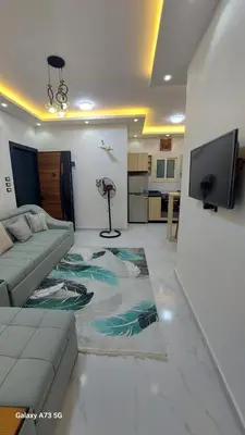 a living room with a couch and a flat screen tv at الغردقه in Hurghada