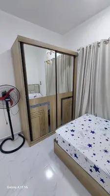 a bedroom with a bed and a mirror at الغردقه in Hurghada