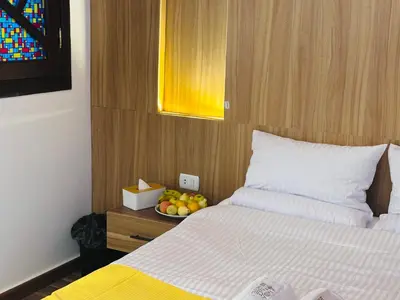 a bedroom with a bed and a bowl of fruit on a table at Farida Djorf Palce in Luxor