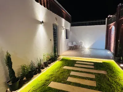 a courtyard with grass and plants in a building at Farida Djorf Palce in Luxor