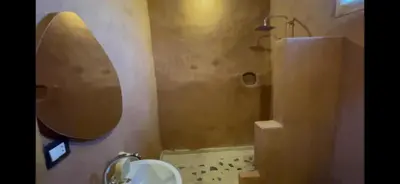 a bathroom with a sink and a shower with a mirror at Massel Belosso in Aswan