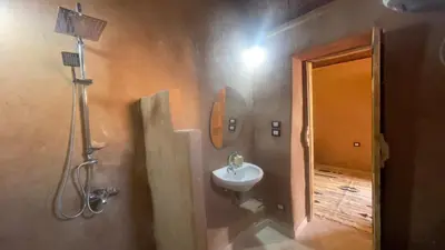 a bathroom with a sink and a shower and a toilet at Massel Belosso in Aswan