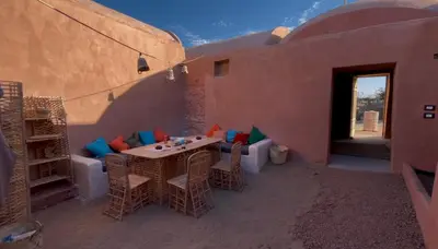 a patio with a table and chairs in a building at Massel Belosso in Aswan