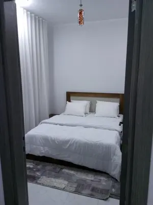 a bedroom with a large bed with white sheets and pillows at Dody apartments rent services in Luxor
