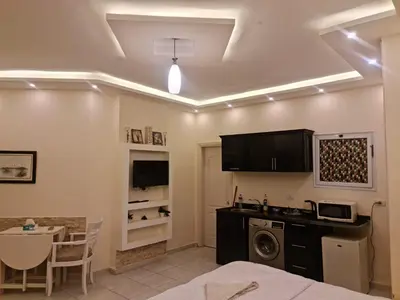 a room with a bed and a kitchen with a washing machine at منتجع اباظة السياحى in Hurghada
