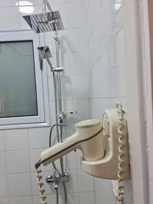 a shower with a hair dryer in a bathroom at منتجع اباظة السياحى in Hurghada