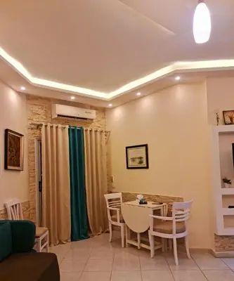 a living room with a table and chairs at منتجع اباظة السياحى in Hurghada