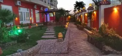 a walkway in front of a house at night at منتجع اباظة السياحى in Hurghada