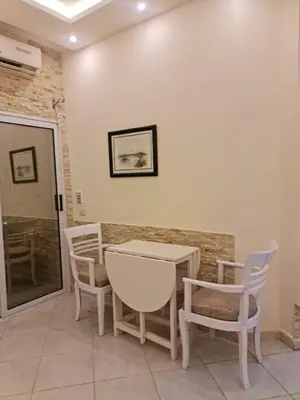 a room with a table and chairs and a window at منتجع اباظة السياحى in Hurghada