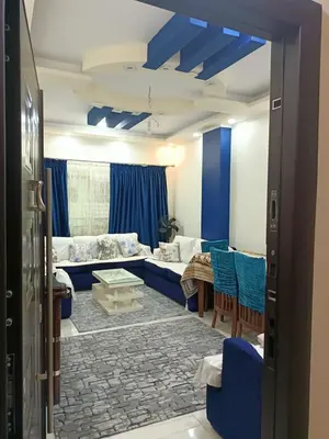 a living room with a blue couch and chairs at Appartment in Hurghada in Hurghada