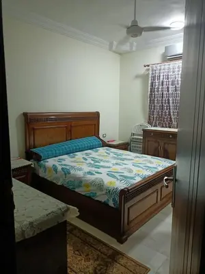 a bedroom with a bed with a blue comforter at Appartment in Hurghada in Hurghada