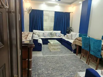 a living room with a blue couch and blue curtains at Appartment in Hurghada in Hurghada