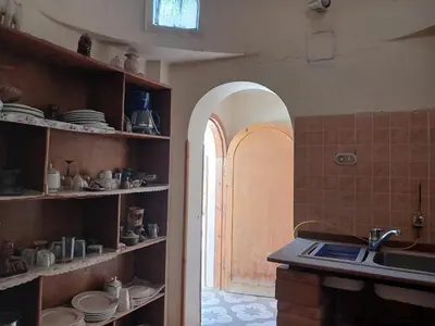 a kitchen with a sink and an archway in a room at Habu view in Al Karnak