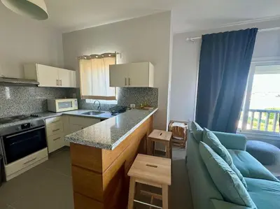 a kitchen with a couch and a counter in a room at waterside apartments in Hurghada