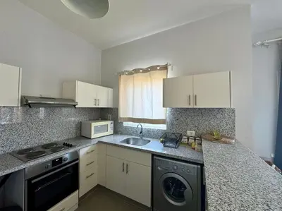 a kitchen with a sink and a dishwasher at waterside apartments in Hurghada