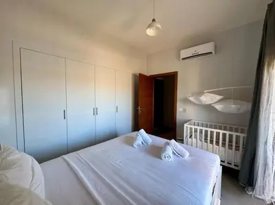 a bedroom with a white bed with two pillows at waterside apartments in Hurghada