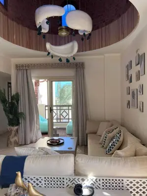 a living room with a couch and a table at Your Red Sea Hideaway Apartment in Coraya Bay