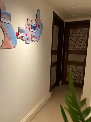 a room with a wall with a door and a plant at Your Red Sea Hideaway Apartment in Coraya Bay