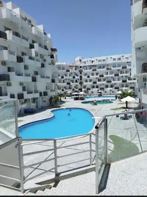a swimming pool on the balcony of a building at Tyba view in Hurghada