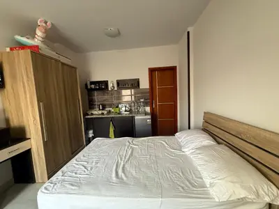 a bedroom with a bed and a kitchen at Tyba view in Hurghada