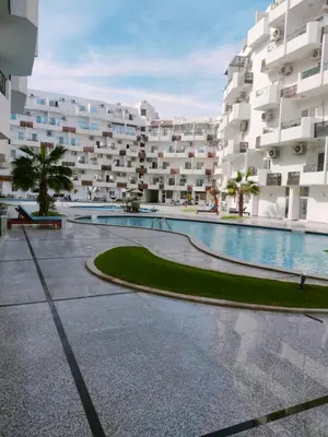 a large apartment building with a large swimming pool at Tyba view in Hurghada