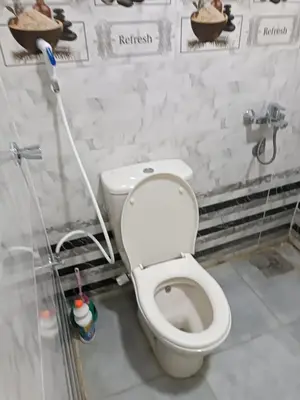 a bathroom with a white toilet in a room at فندق الإيمان El Eman Hotel in Maḩaţţat Idfū