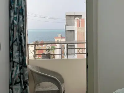 a view of the ocean from a balcony with a chair at Dream apartment2 in Hurghada