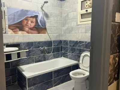 a child is peeking through a mirror in a bathroom at Dream apartment2 in Hurghada