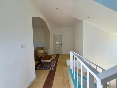 a living room with a staircase and a chair at Sylvie guest house in Luxor