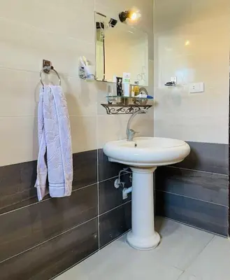 a bathroom with a white sink and a mirror at Mado luxury villa with private pool in Luxor