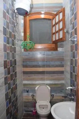 a small bathroom with a toilet and a sink at Mado luxury villa with private pool in Luxor