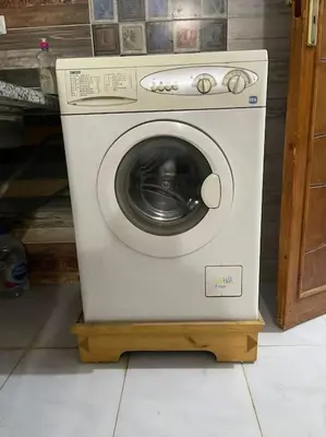 a washing machine sitting on a stand in a room at El Hady villa with swimming pool in Luxor