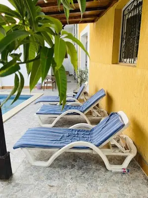 three blue and white lounge chairs on a patio at El Hady villa with swimming pool in Luxor