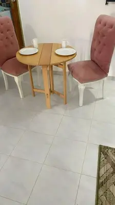 two chairs and a table and a table and two chairs at El Hady luxury apartment with swimming pool in Luxor