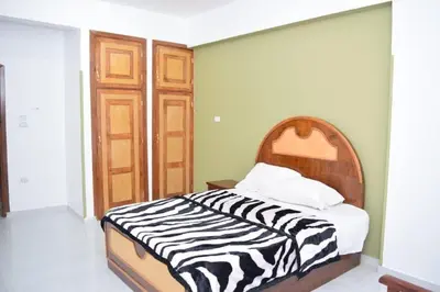 a bed in a room with a zebra print blanket at El Hady luxury apartment with swimming pool in Luxor