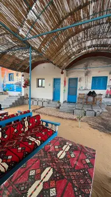 a group of beds in a building with a roof at Hannag Island Guest house in Aswan