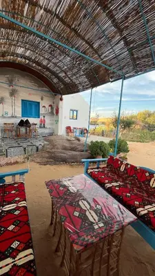 a group of tables and chairs under a roof at Hannag Island Guest house in Aswan