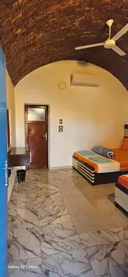 a bedroom with a bed and a piano in it at Hannag Island Guest house in Aswan
