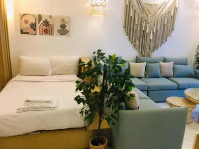 a living room with a bed and a blue couch at Fanadir Bay in Hurghada