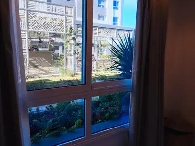 an open window with a view of a garden at Fanadir Bay in Hurghada