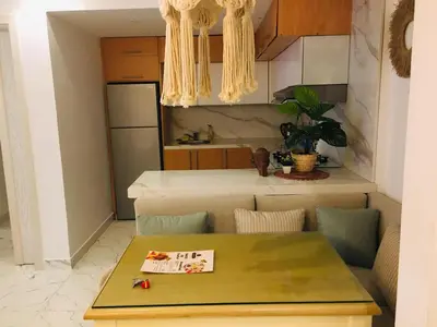 a kitchen with a table with a sign on it at Fanadir Bay in Hurghada