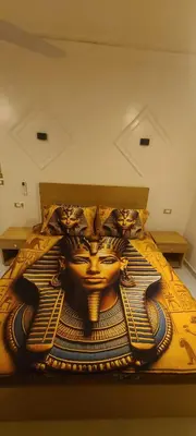 a bedroom with a bed with a painting on it at Luxor Sapphire in Luxor