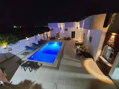 an overhead view of a swimming pool at night at Luxor Sapphire in Luxor