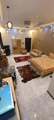 a large room with a bed and a couch and tables at Luxor Sapphire in Luxor