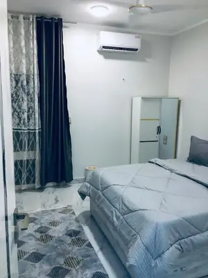 a bedroom with a large bed and a window at Diamond Guest House K in Aswan