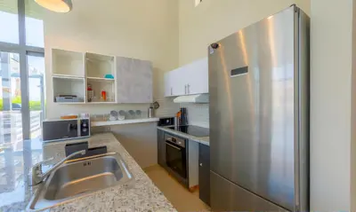a kitchen with a stainless steel refrigerator and a sink at Luxury Villas in Tawila El Gouna in Hurghada