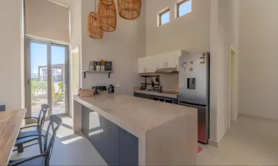 a kitchen with a counter top and a refrigerator at Luxury Villas in Tawila El Gouna in Hurghada