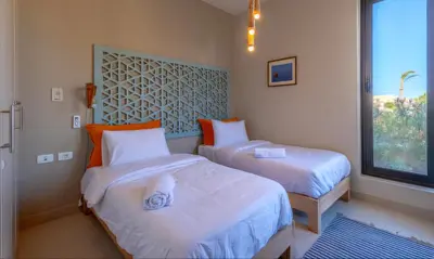 a bedroom with two beds and a window at Luxury Villas in Tawila El Gouna in Hurghada