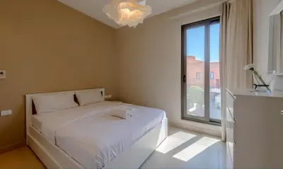 a bedroom with a bed and a large window at Luxury Villas in Tawila El Gouna in Hurghada