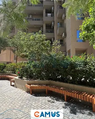 a park with benches in front of a building at CAMUS 117 B, Princess Resort in Hurghada